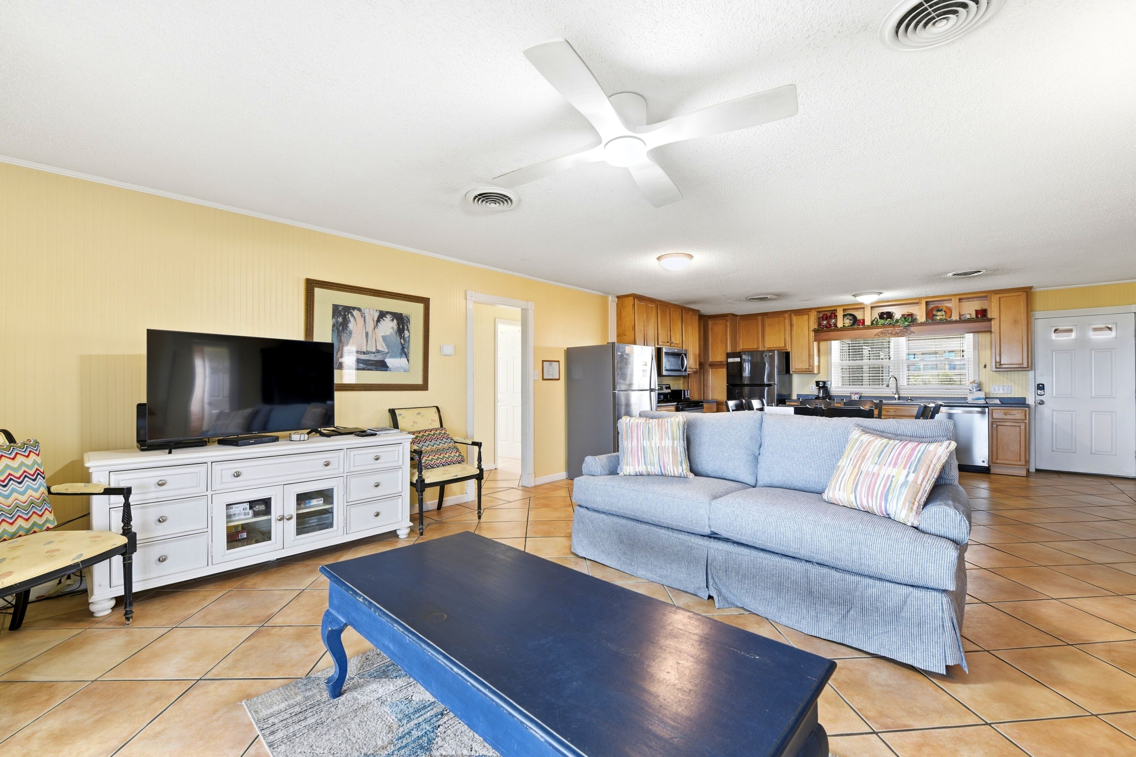 A living room with a TV, sofa, and coffee table.