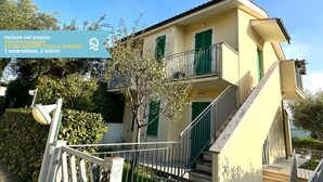 A two-story building with a balcony, a staircase, and a satellite dish. - N148 - Numana, new three-room apartment with terrace 350mt from the sea (Numana)