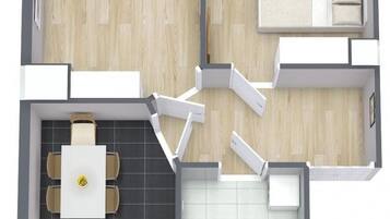 Plano de un cuarto de hotel que incluye sala de estar, comedor, cocina y baño.
