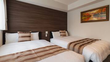 A hotel room with two beds, a wooden headboard, and a painting on the wall.