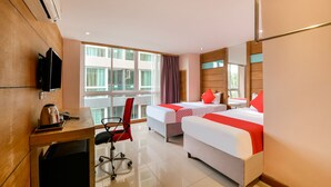 A hotel room with two beds, a desk, a chair, a TV, and a window with curtains. - OYO 143 Dday Resotel Pattaya Hotel (Pattaya)