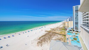 A beach resort with a pool area, beach umbrellas, and a view of the ocean. - Royal Palms 1BR 2BA! Condo 1007 ~ (Gulf Shores)