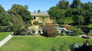 A residential property with a swimming pool, a well-maintained garden, and a clear view of the surrounding landscape. - Résidence Le Home (Calvi)