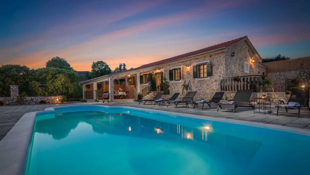 A stone building with a pool and outdoor seating. - Beautiful 3-BR villa with pool and sea view just above Rogoznica (Rogoznica)