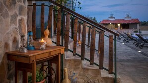 A wooden table with a lantern, candle, and vase on a stone wall. - Beautiful 3-BR villa with pool and sea view just above Rogoznica (Rogoznica)