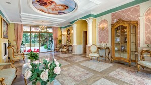 A luxurious room with ornate furniture, a large chandelier, and a grand ceiling mural. - Venera & Anastasia Palace Apartments (Sunny Beach)