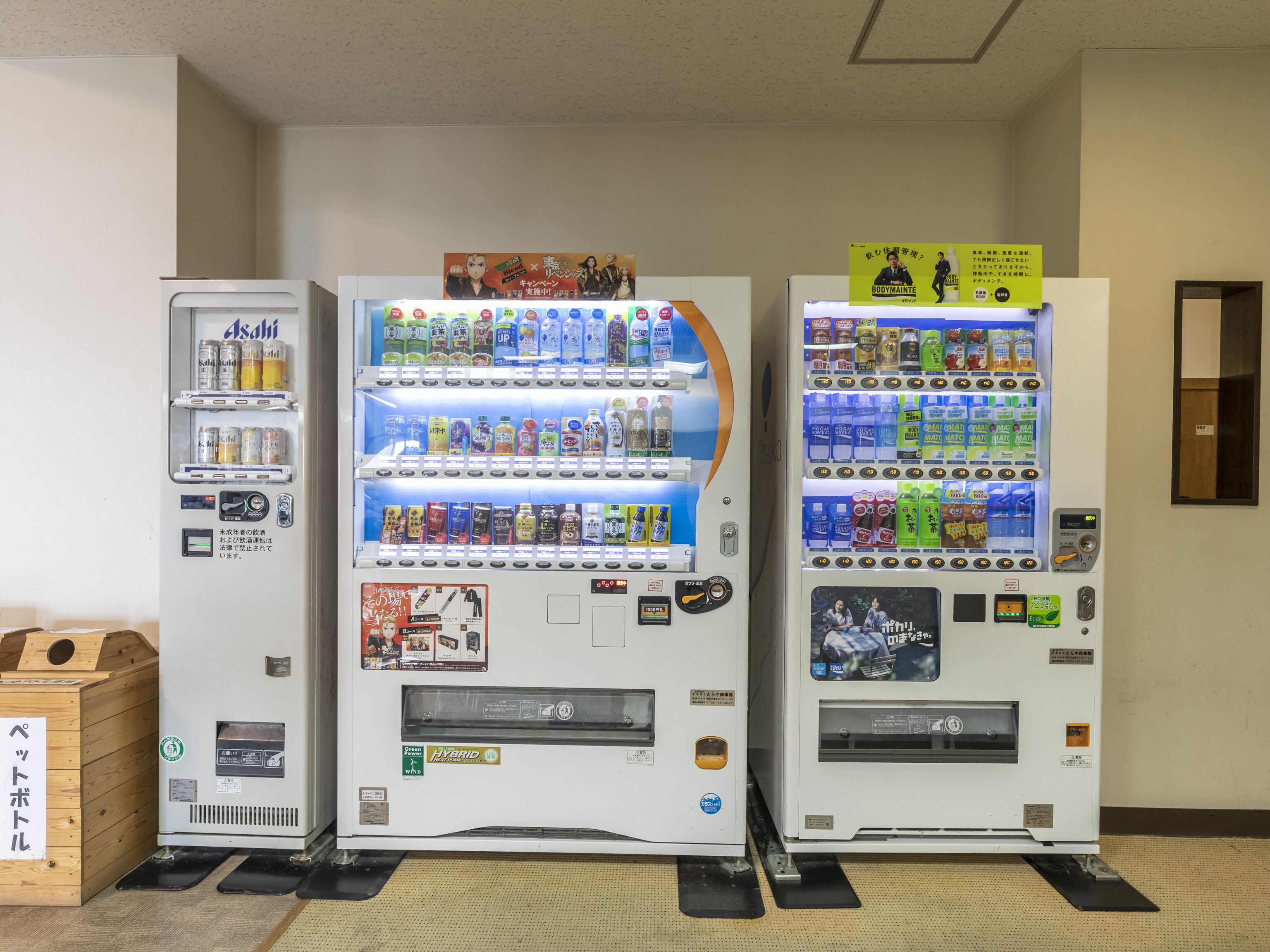 Three vending machines with various beverages and snacks.