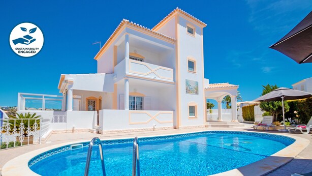 A two-story building with a swimming pool in front.