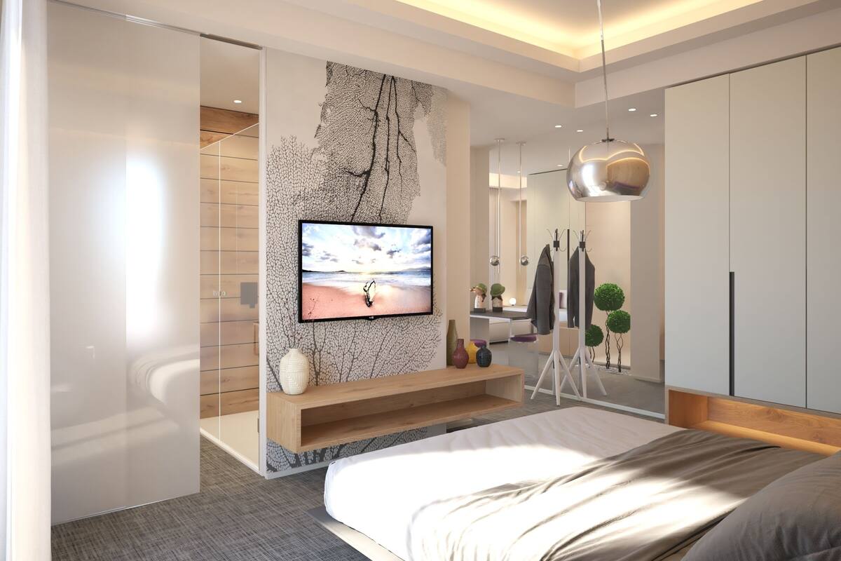 A modern bedroom with a large bed, a TV mounted on a textured wall, a mirror, and a wardrobe.