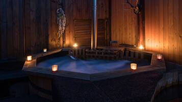 A wooden sauna with benches and candles.