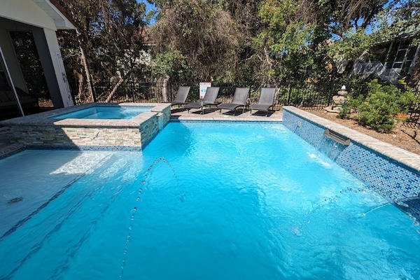 Salt-water pool and spa w tanning shelf, fountains, deck jets and water falls.