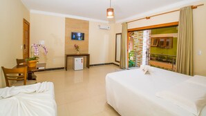 Ein Hotelzimmer mit Bett, Schreibtisch, Stuhl, kleinem Kühlschrank, Fernseher und einem Balkon mit Blick.