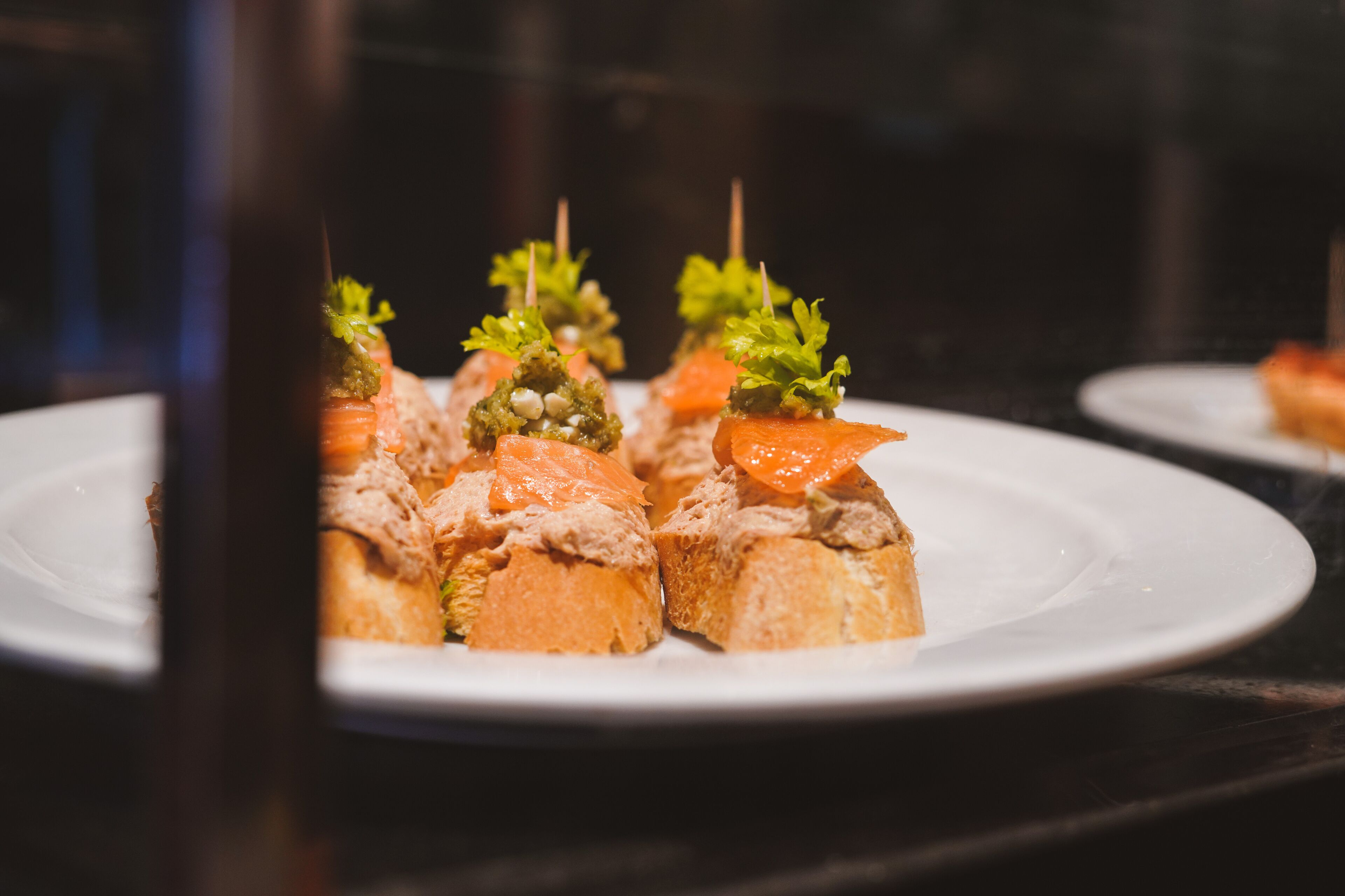 A plate of appetizers with toothpicks.