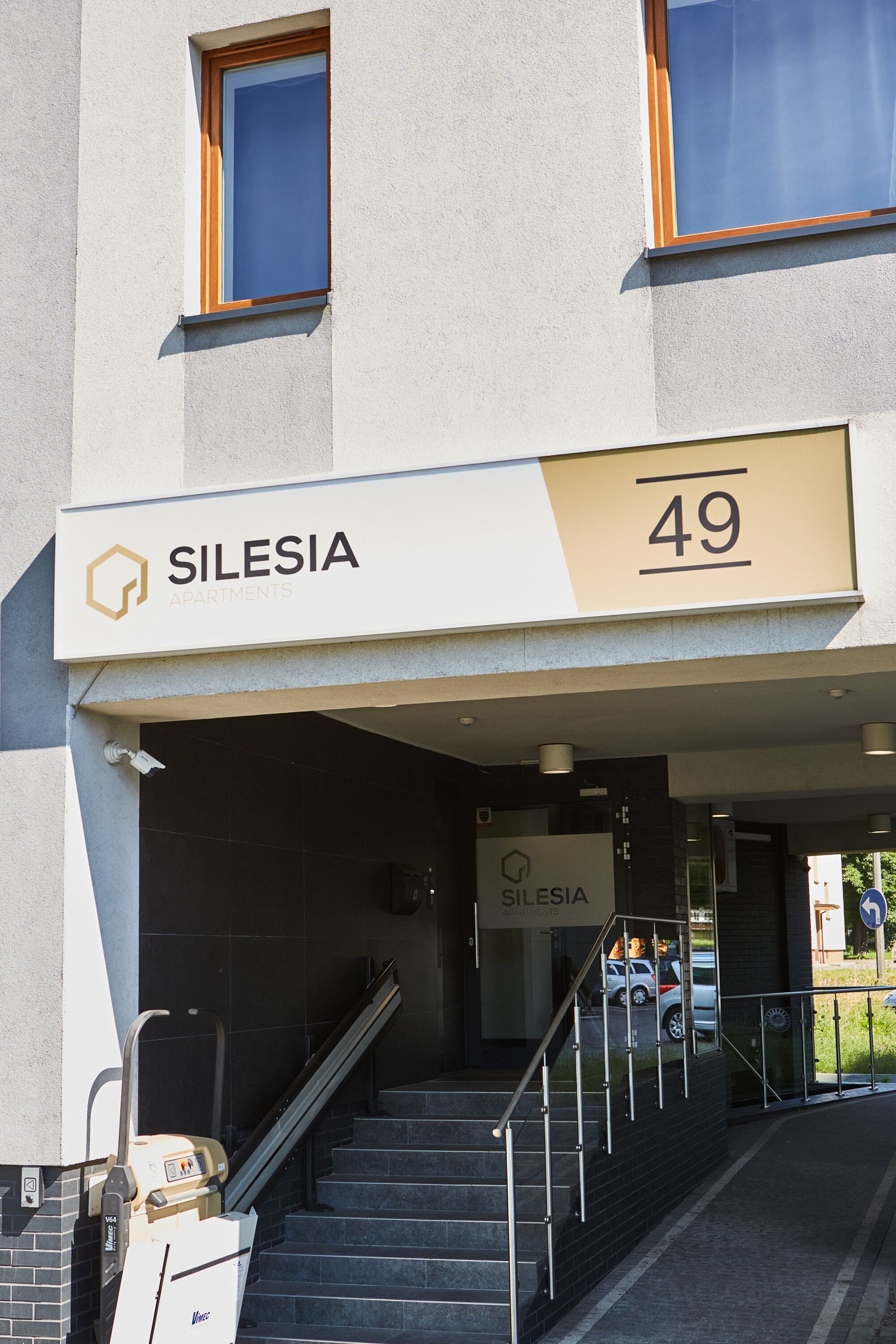 A building entrance with a sign reading "SILESIA APARTMENTS 49".