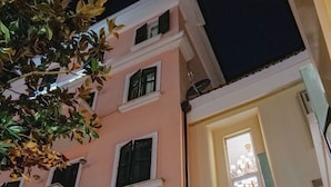 A building with a restaurant sign, a staircase, and a potted plant. - Hotel Boka (Tirana)
