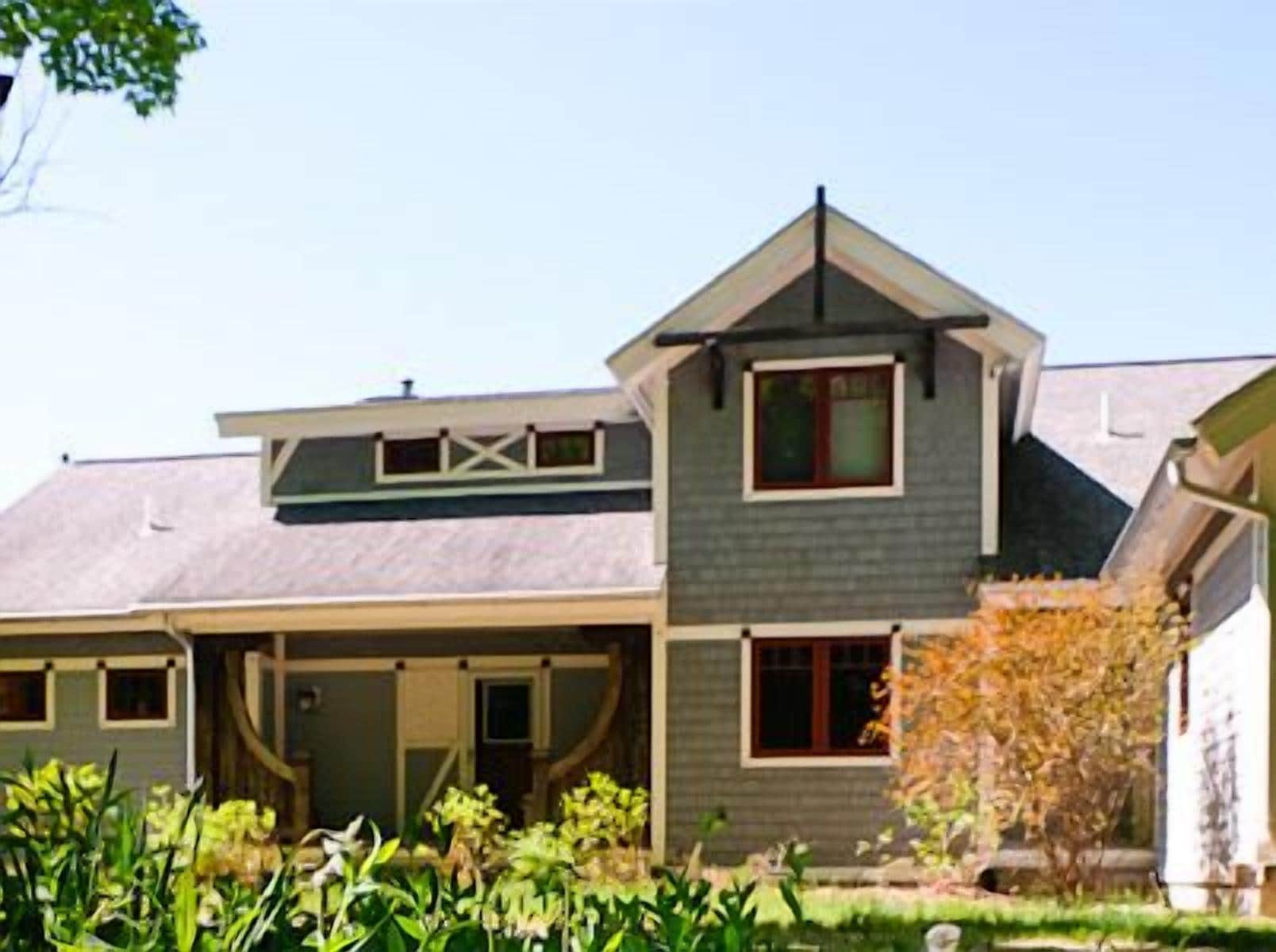 Front of house with a circle drive and covered porch