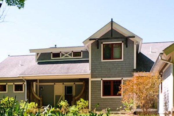 Front of house with a circle drive and covered porch