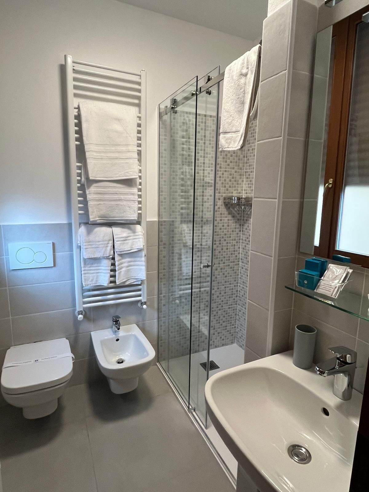 Une salle de bain moderne équipée de toilettes, d’un bidet et d’un lavabo.