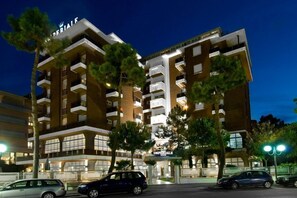 A multi-story hotel with a prominent "IMPERIALE" sign, featuring balconies and a modern architectural design. - Hotel Imperiale (Cervia)