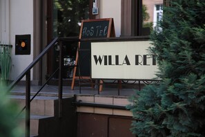 A sign for "WILLA RETT" with a "HOSTEL" sign above it.