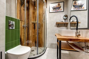A modern bathroom with a glass-enclosed shower, a white toilet, and a wooden vanity with a sink and mirror. - Mountain Lake Hotel (Smolyan)