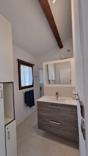 Shower, hair dryer, towels, toilet paper