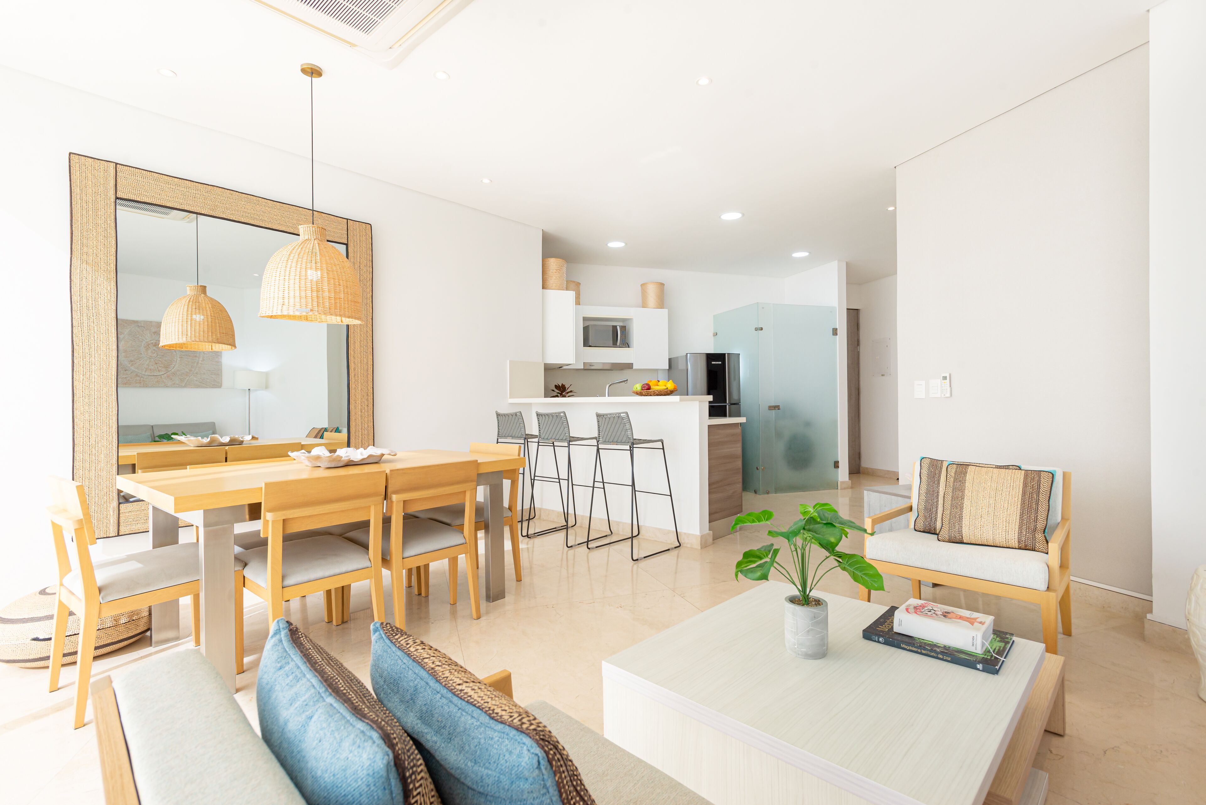 A modern kitchen with white cabinets, a built-in microwave, and a refrigerator.