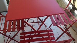 A red metal table and chairs set on a tiled floor. - 47m2 duplex apartment - type 2 with terrace (Frejus)