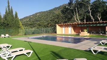 Een seizoensgebonden buitenzwembad, parasols voor strand/zwembad