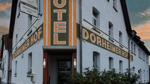 A two-story building with a sign reading "HOTEL DORHEIMER HOF" and a smaller sign above it reading "DORHEIMER HOF".