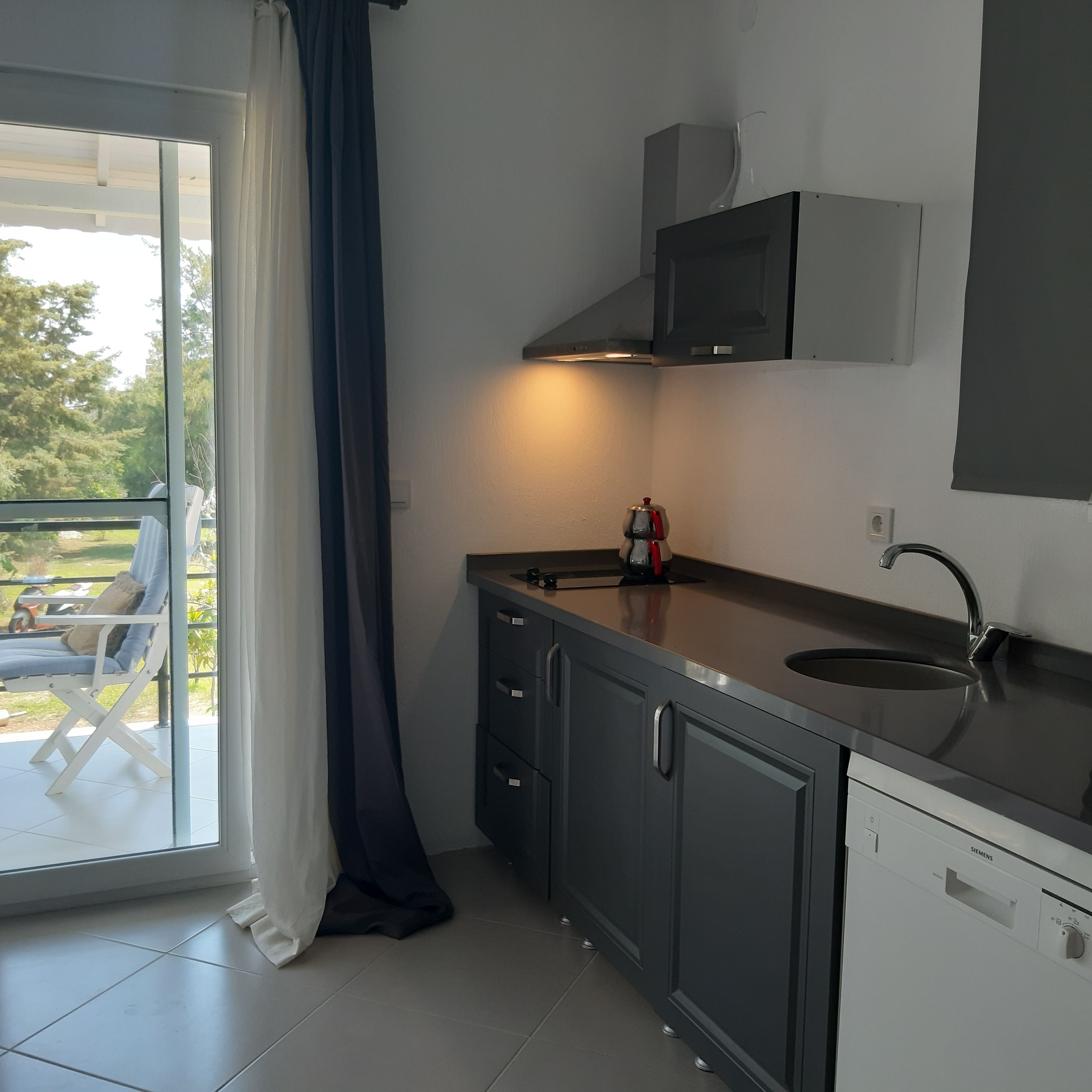 deluxe apartment | private kitchenette | full-sized fridge, dining tables