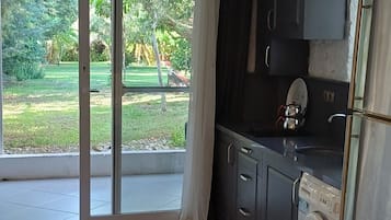 Club Triple Room, Garden View | Private kitchen | Full-sized fridge, dining tables