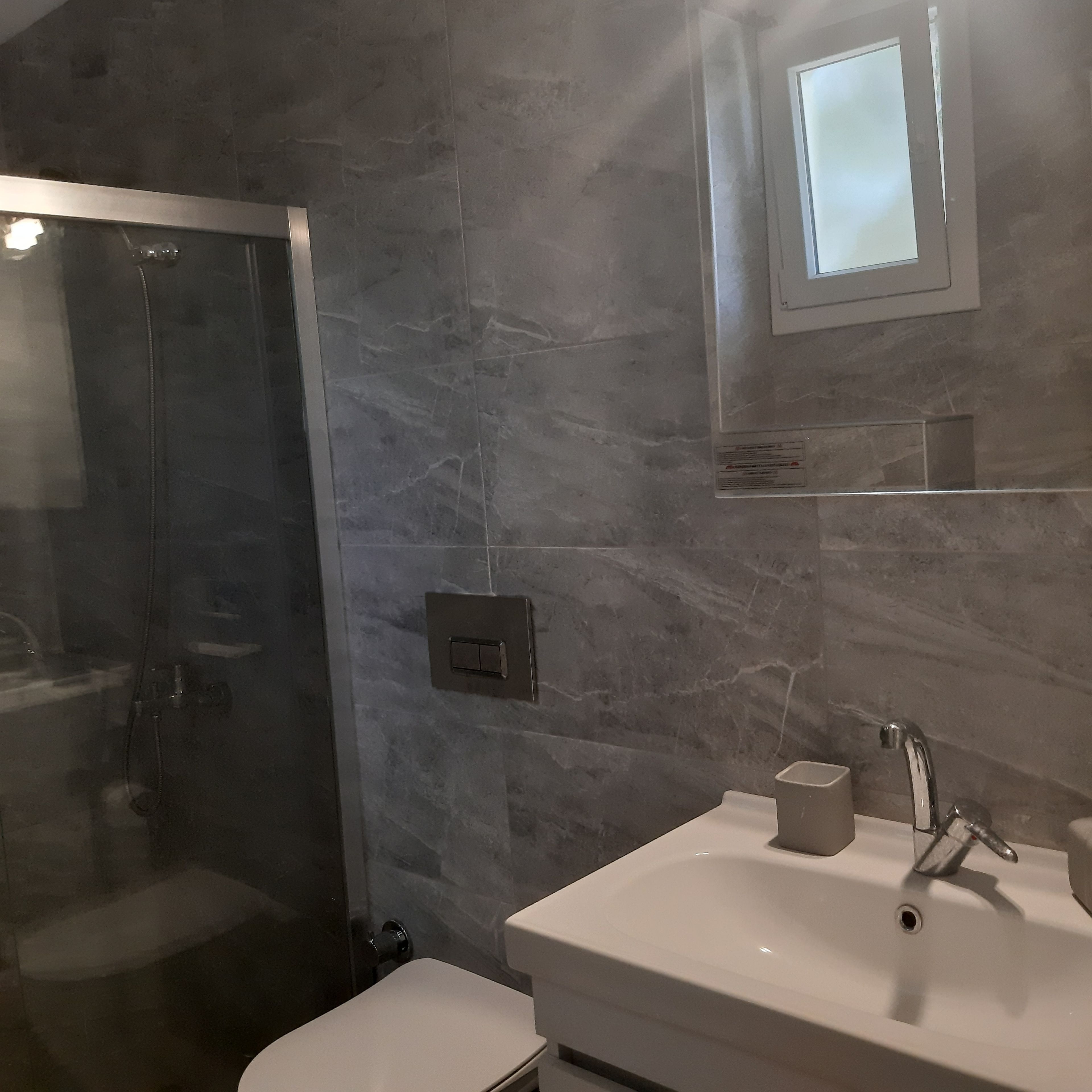 deluxe apartment | bathroom | shower, rainfall showerhead, hair dryer