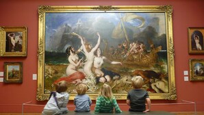 Interior de museu com uma grande pintura clássica na parede, um banco para apreciar a obra e outras obras de arte em exposição.