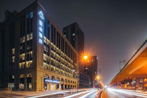 A hotel with a modern facade, large windows, and a prominent sign. - Atour Hotel West Lake Cultural Square Shangtang Rd Hangzhou (Hangzhou)
