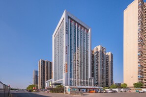 A high-rise building with multiple floors, large windows, and a prominent entrance. - Atour Hotel Lugu Changsha (Changsha)
