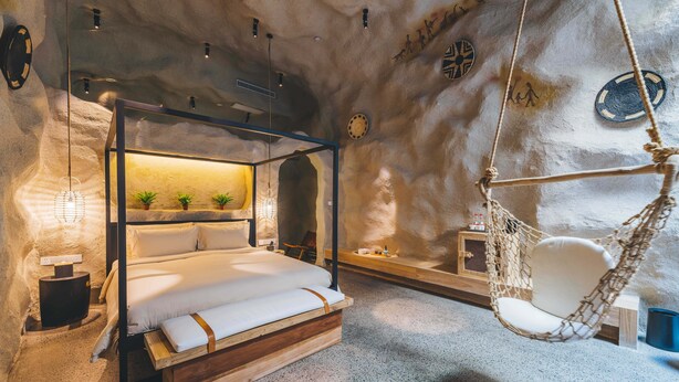 A cozy bedroom with a four-poster bed, a hanging chair, and a small bedside table. - Atour Hotel Hongen Road Forest Park Chongqing (Chongqing)