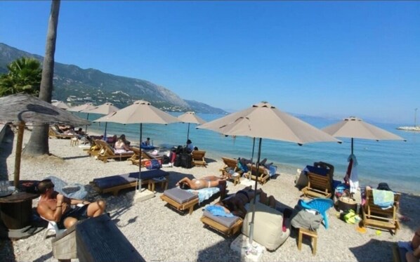 On the beach, sun-loungers