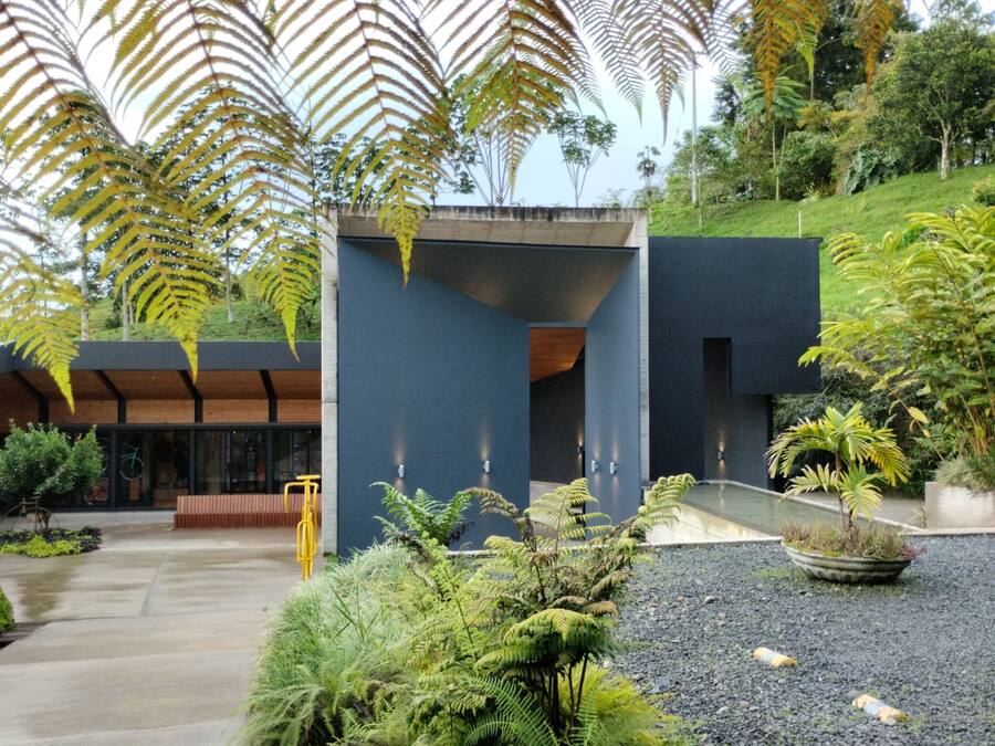 A modern building with a concrete facade and a sloped roof.