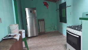Full-sized fridge, oven, stovetop, cookware/dishes/utensils