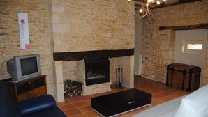 Cottage, 1 Bedroom (Orchidée) | Living room | Flat-screen TV, fireplace - Camping La Castillonderie - Gites (Thonac)