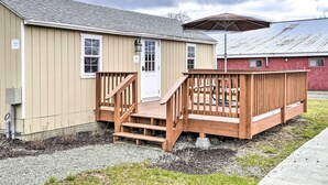 A small, single-story building with a wooden deck and a covered patio area. - Equestrian House- Estonian Suite (Pleasant Mount)