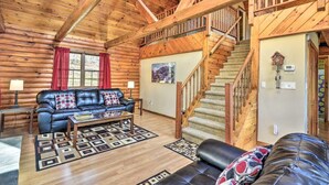A log cabin interior with a living room, a staircase, and a fireplace. - Equestrian House- Log Cabin (Pleasant Mount)