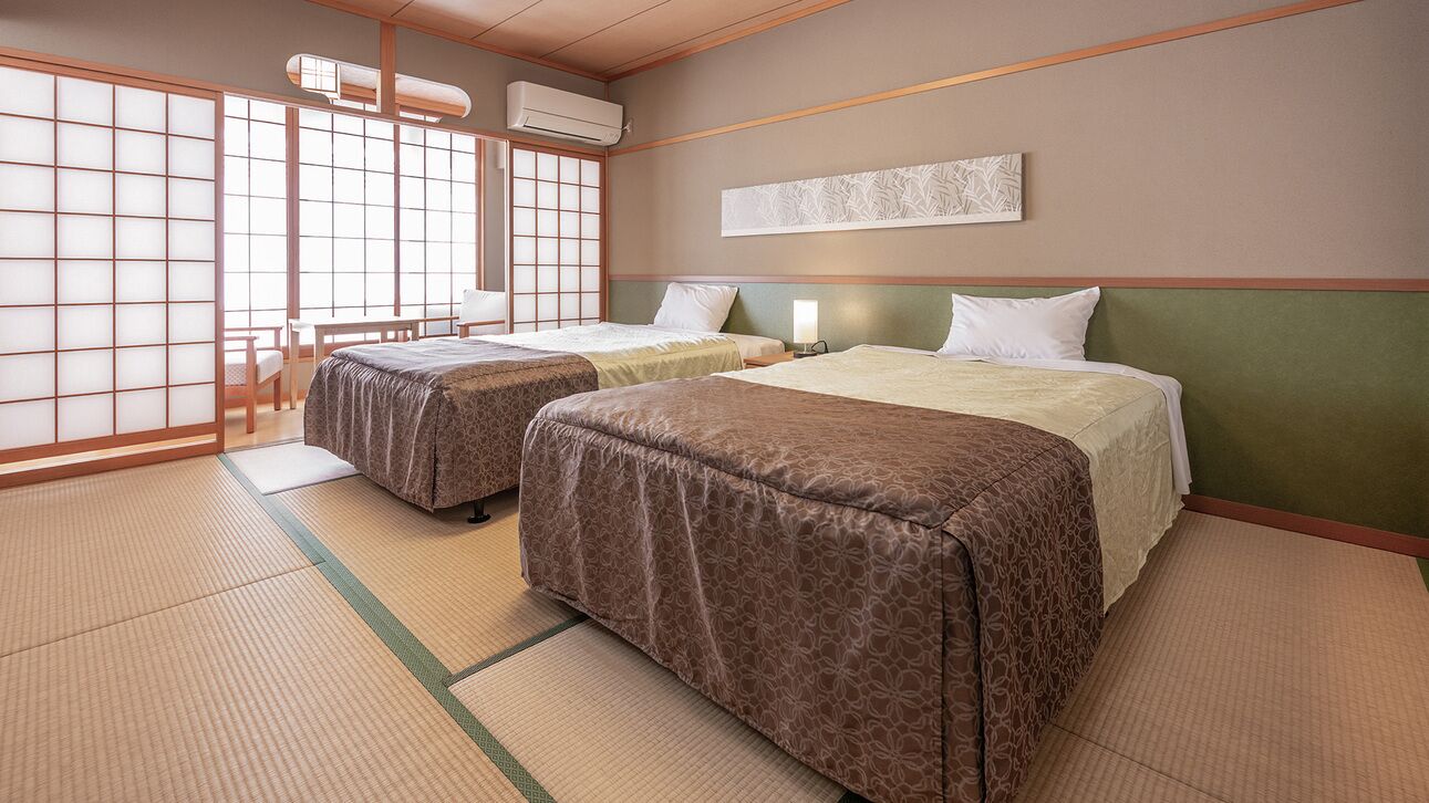 A traditional Japanese-style room with tatami flooring, two beds, a shoji screen, and a futon.