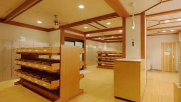 A room with bunk beds, wooden cabinets, and a reception desk.