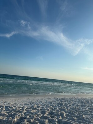 A beach with a clear sky and ocean waves.