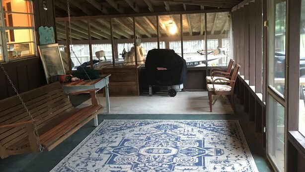 A covered porch with a swing, a bench, a baby stroller, and a grill. - LOTS of parking for vehicles and boats. Large porch with swing and table, chairs (Steinhatchee)