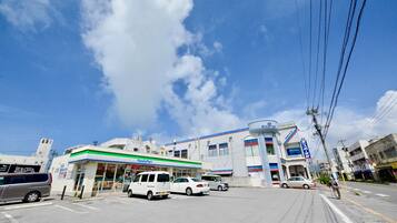 A FamilyMart store with a white van parked in front.