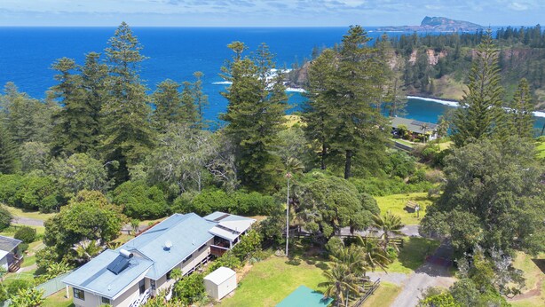 A coastal property with a house, a small boat dock, and a view of the ocean. - Bucks Point House (Norfolk Island)