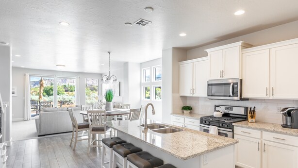 A spacious kitchen with white cabinets, a granite countertop, and stainless steel appliances. - Spacious 4BR Sleeps 12 - 2 Rec Rooms on the 18th (St. George)